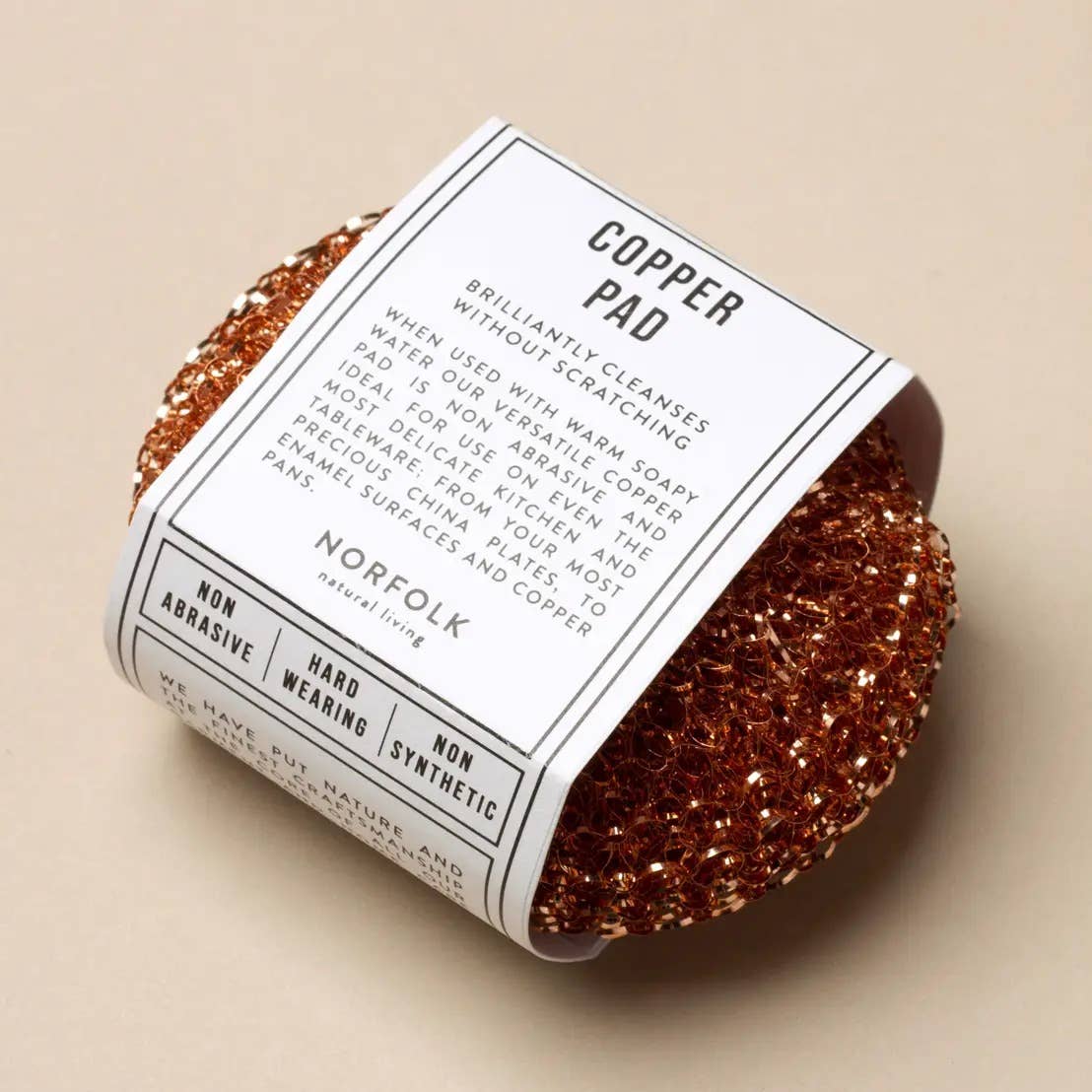 Copper pad with packaging on a beige background