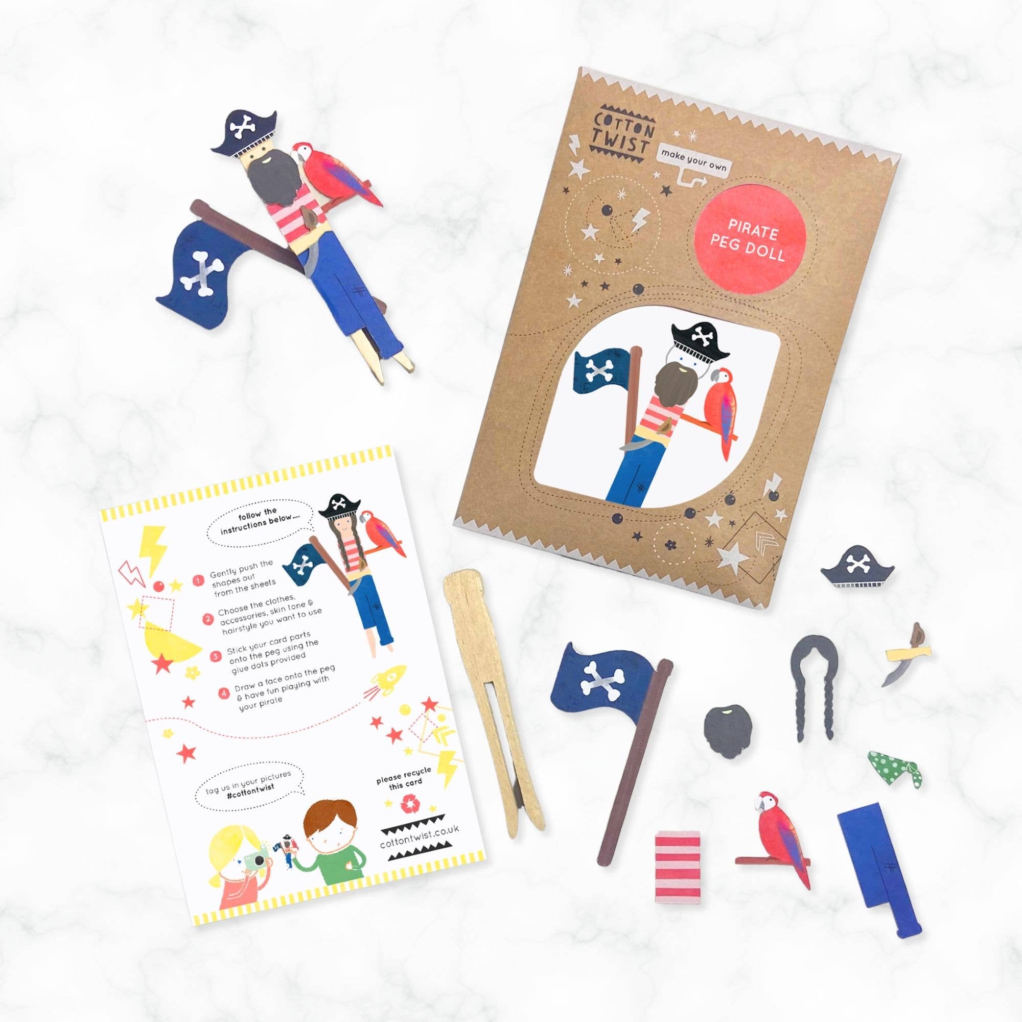 Pirate-themed playset with peg dolls, flags, and instructions on a white background
