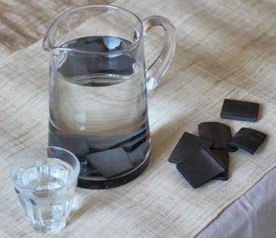 A large water jug with charcoal filters in the bottom