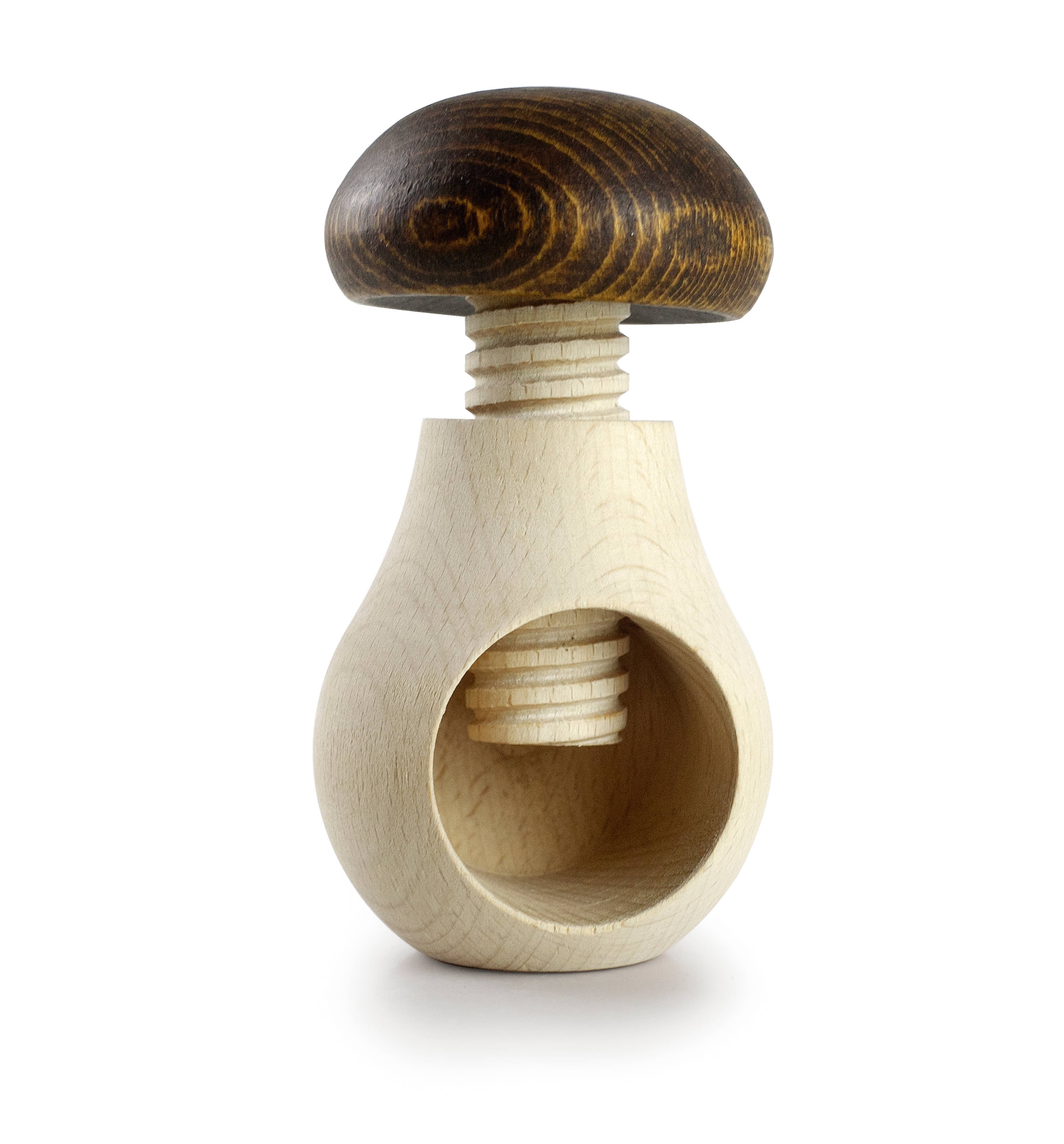 Wooden nutcracker with a dark brown cap on a white background