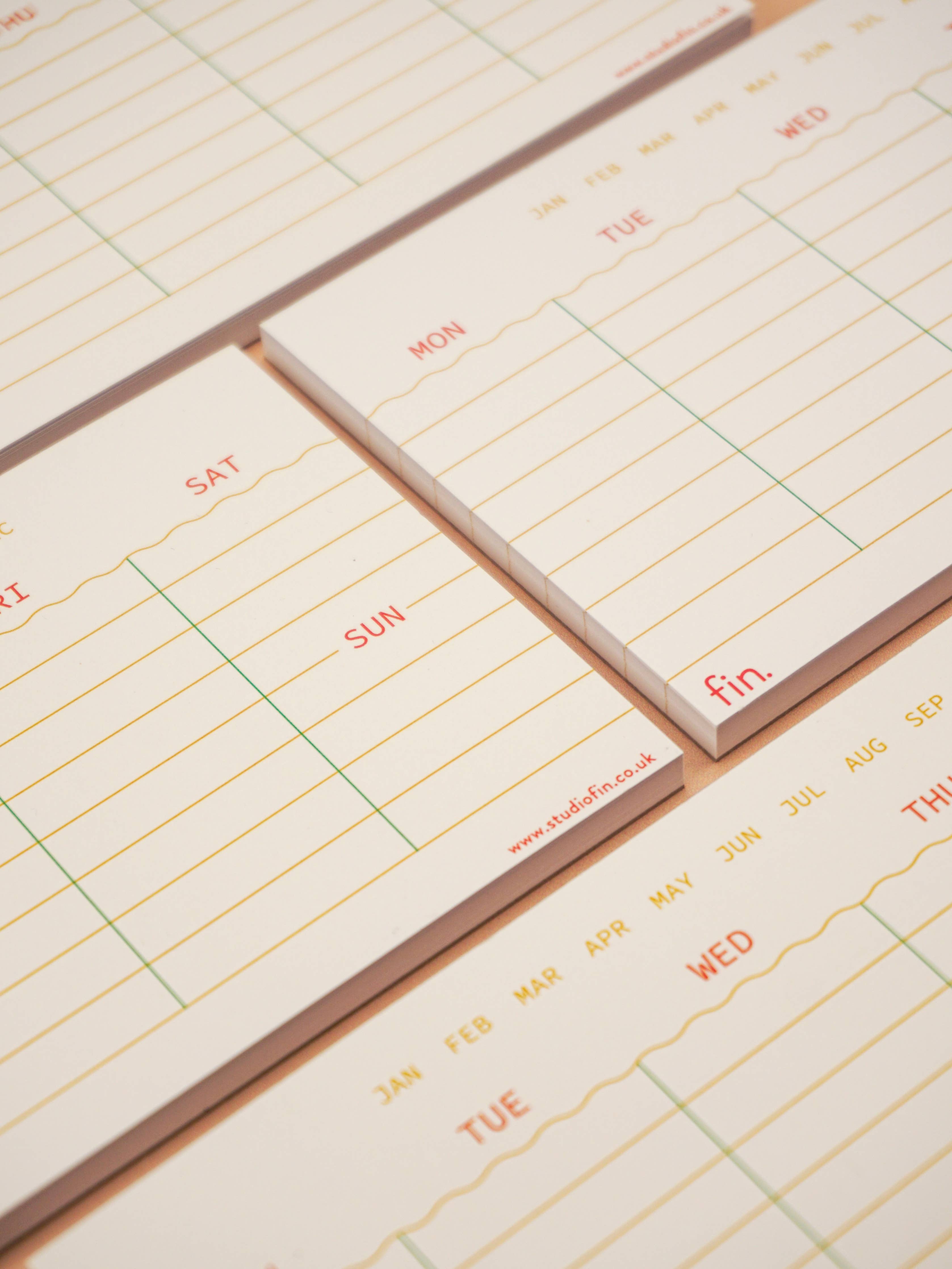 Small calendar pads with days of the week printed on them.