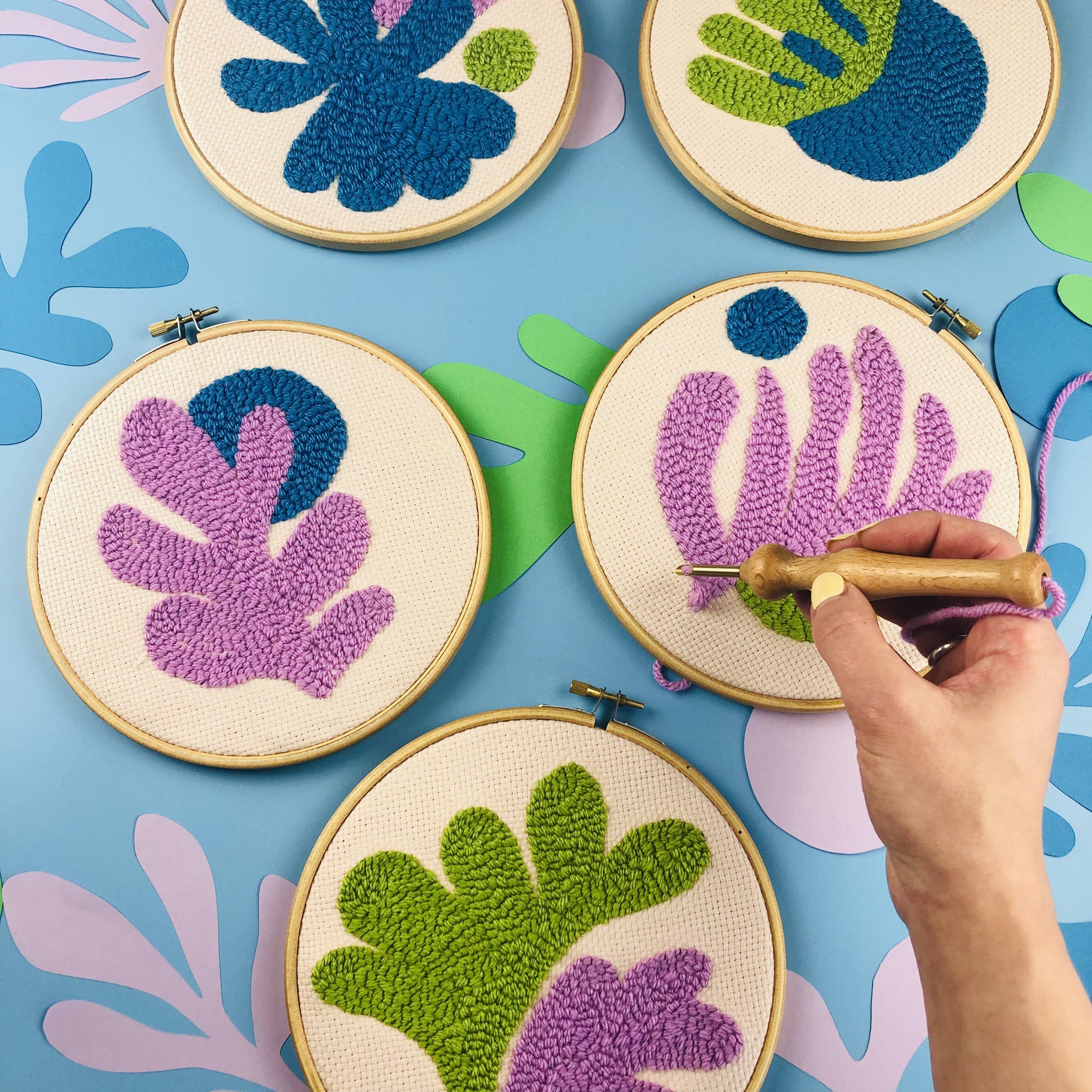 Embroidery hoops with leaf patterns on a blue background