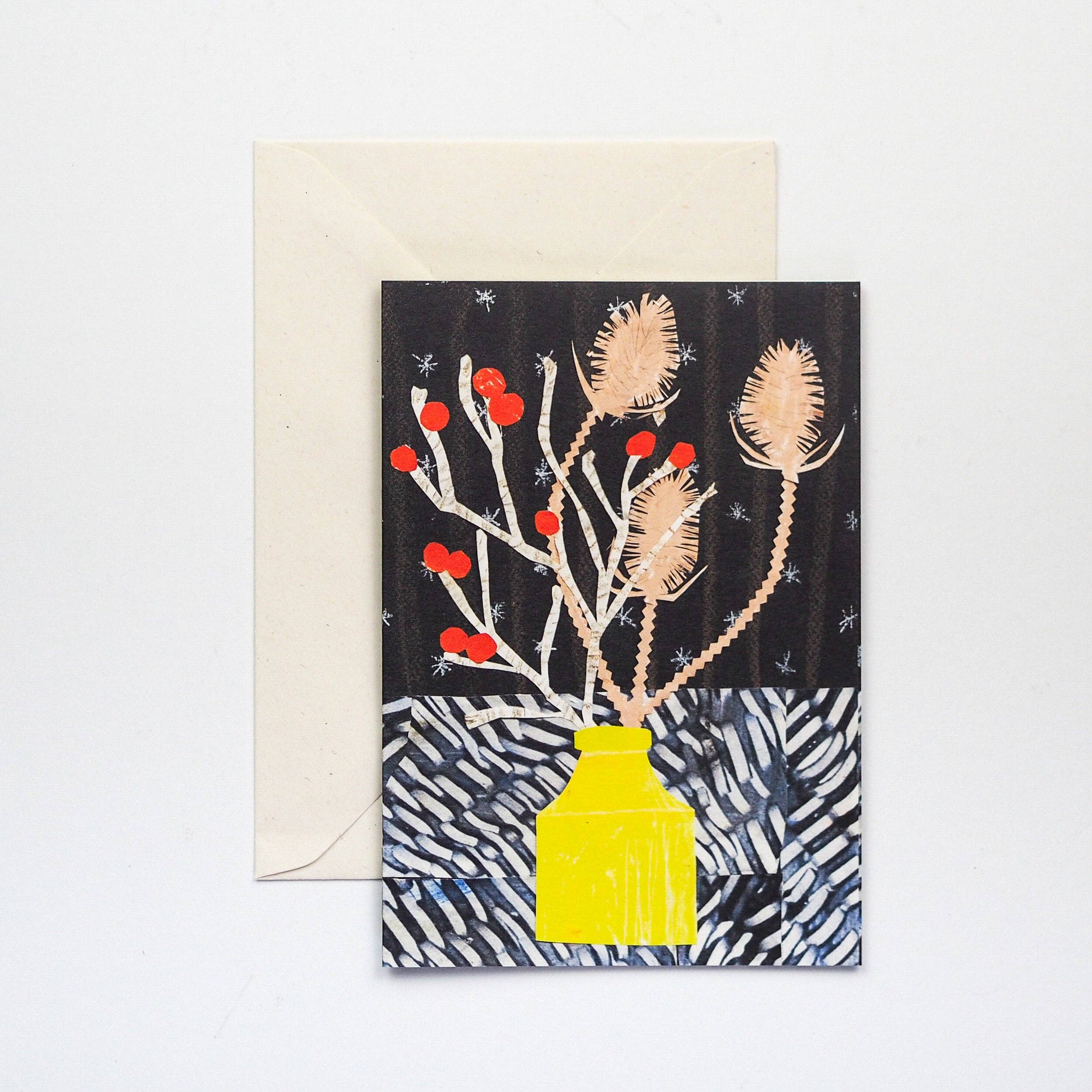 Greeting card with a yellow vase and floral design on a black background, accompanied by a beige envelope.