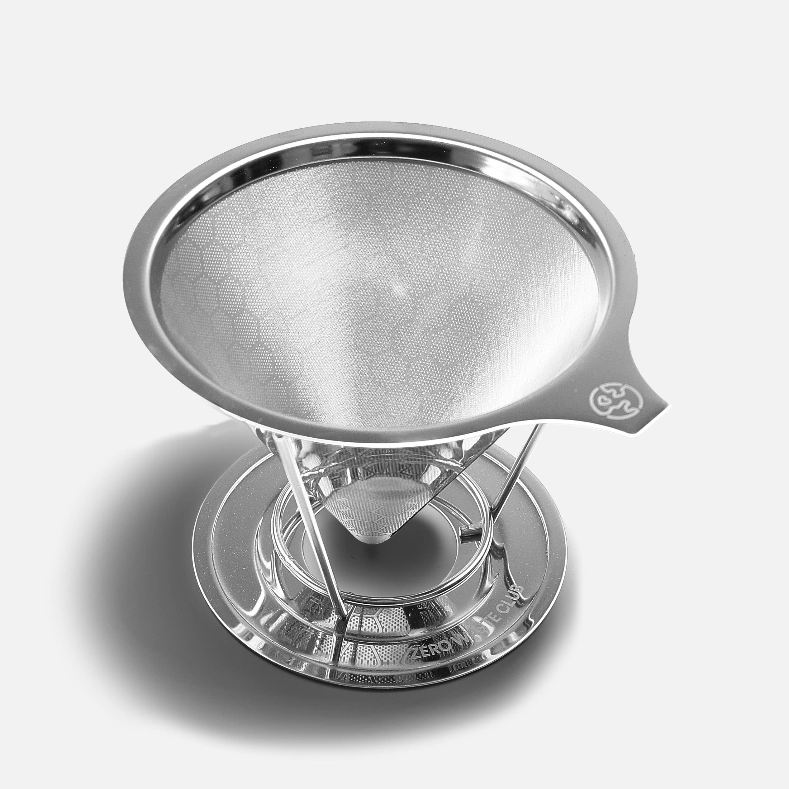 Stainless steel coffee filter on a light grey background