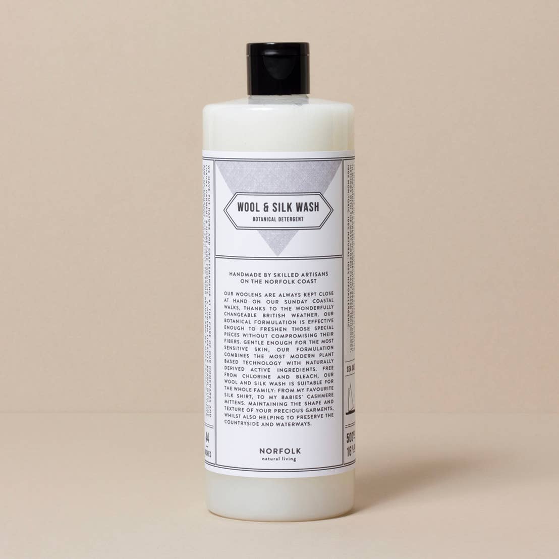 Bottle of Wool & Silk Wash on a beige background