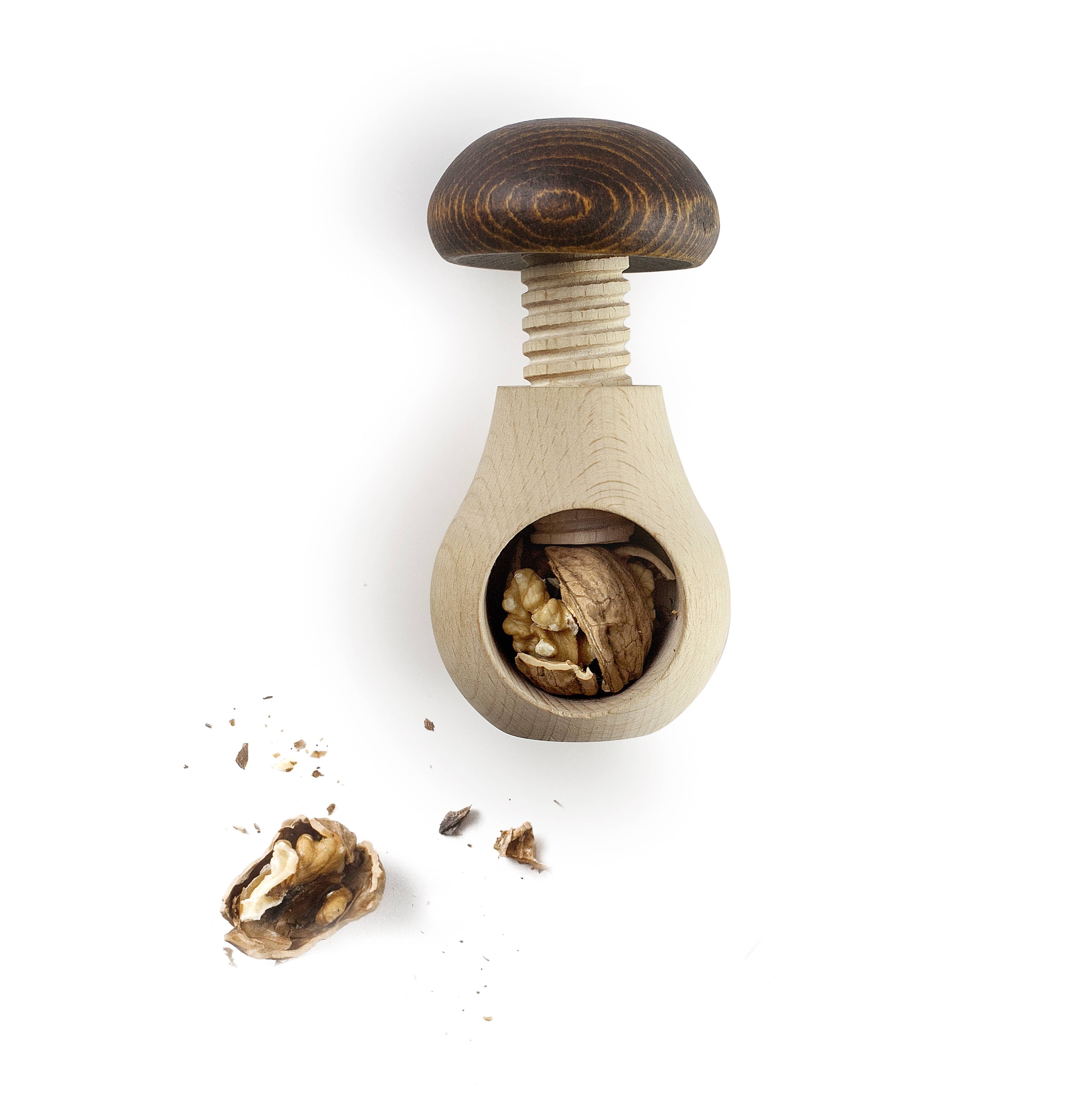 Wooden nutcracker with cracked walnuts on a white background