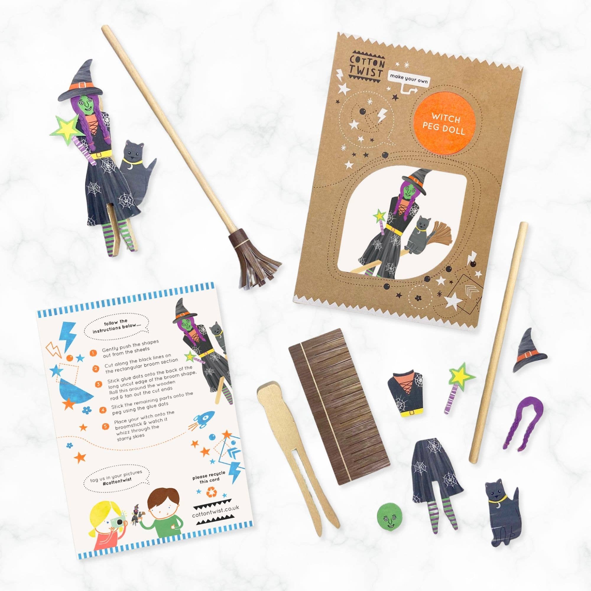 Witch-themed craft kit with broom, costume pieces, and instructions on a white background