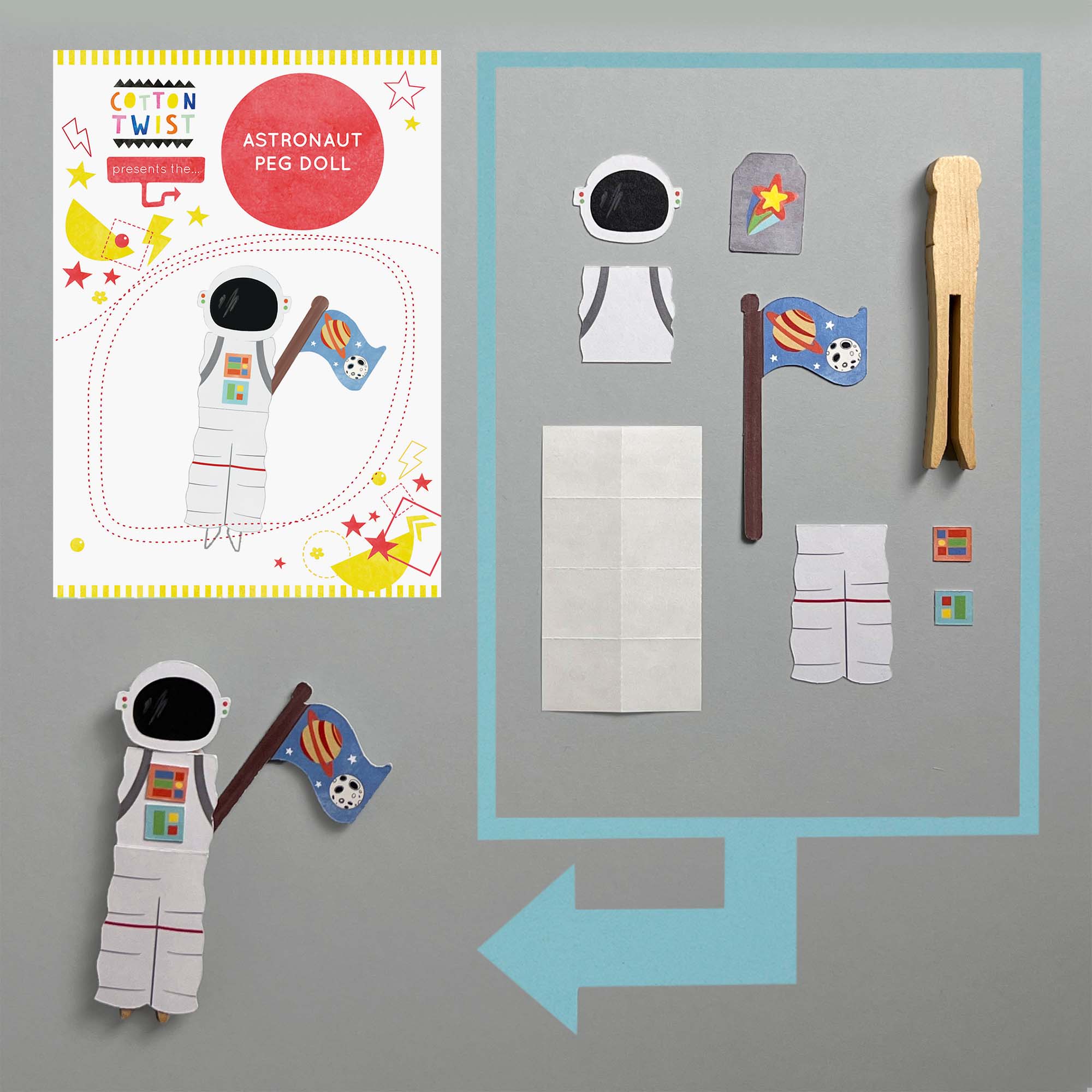 Astronaut peg doll set with paper pieces and a peg on a gray background