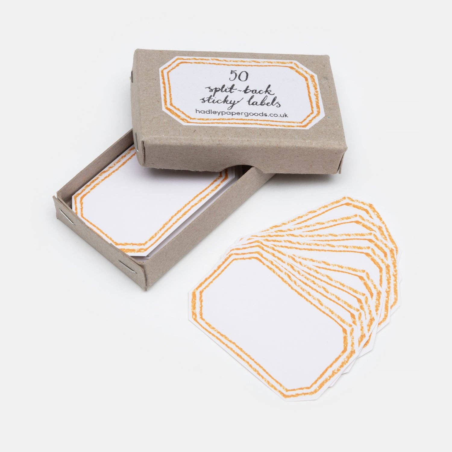 Box of hexagonal sticky labels with a printed label on a white background