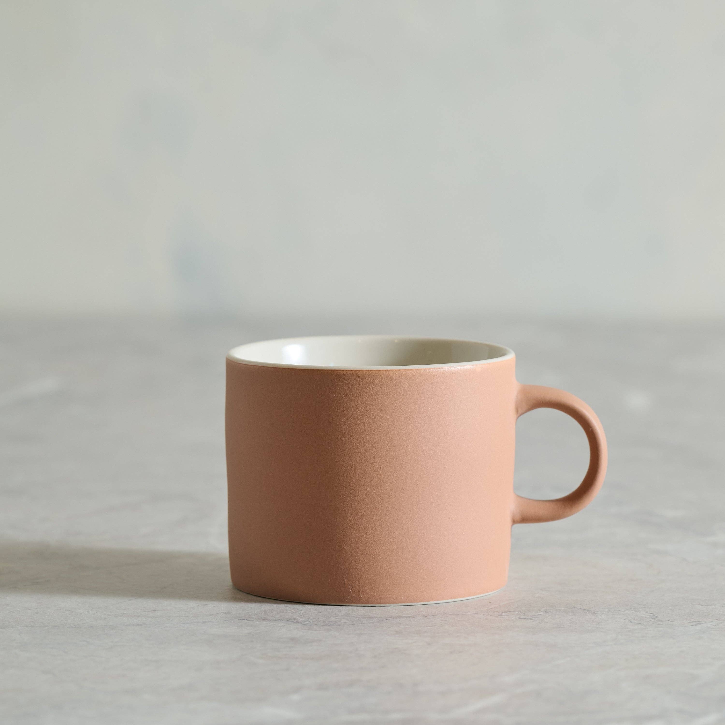 Pink mug on a light gray background