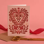 valentine card with folk art including hands and brids motifs