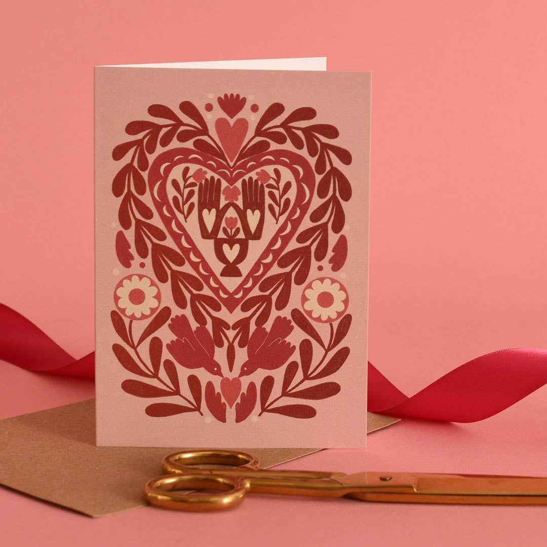 valentine card with folk art including hands and brids motifs
