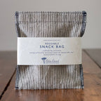 Reusable snack bag with a label on a wooden surface