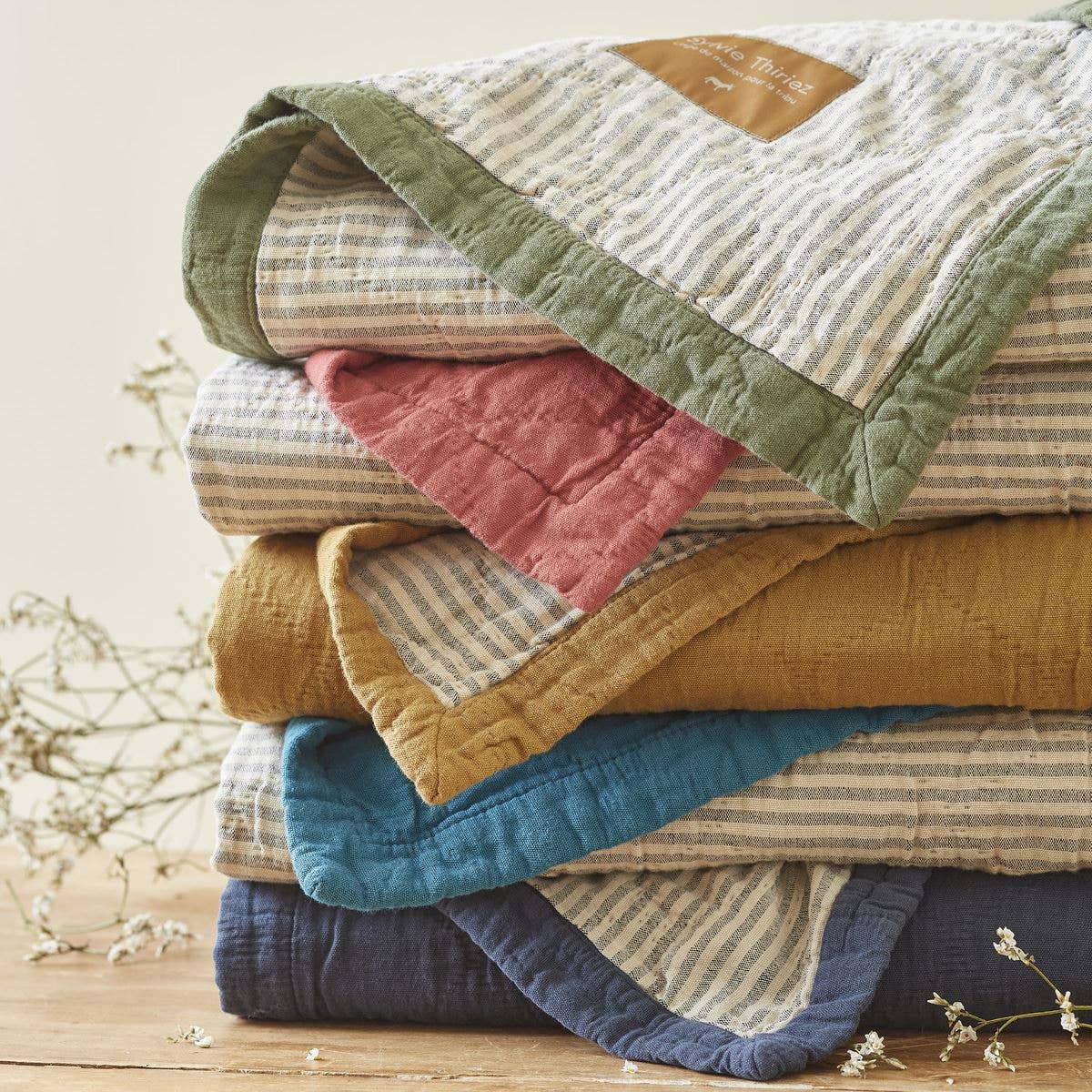 Stack of colorful quilted blankets 
