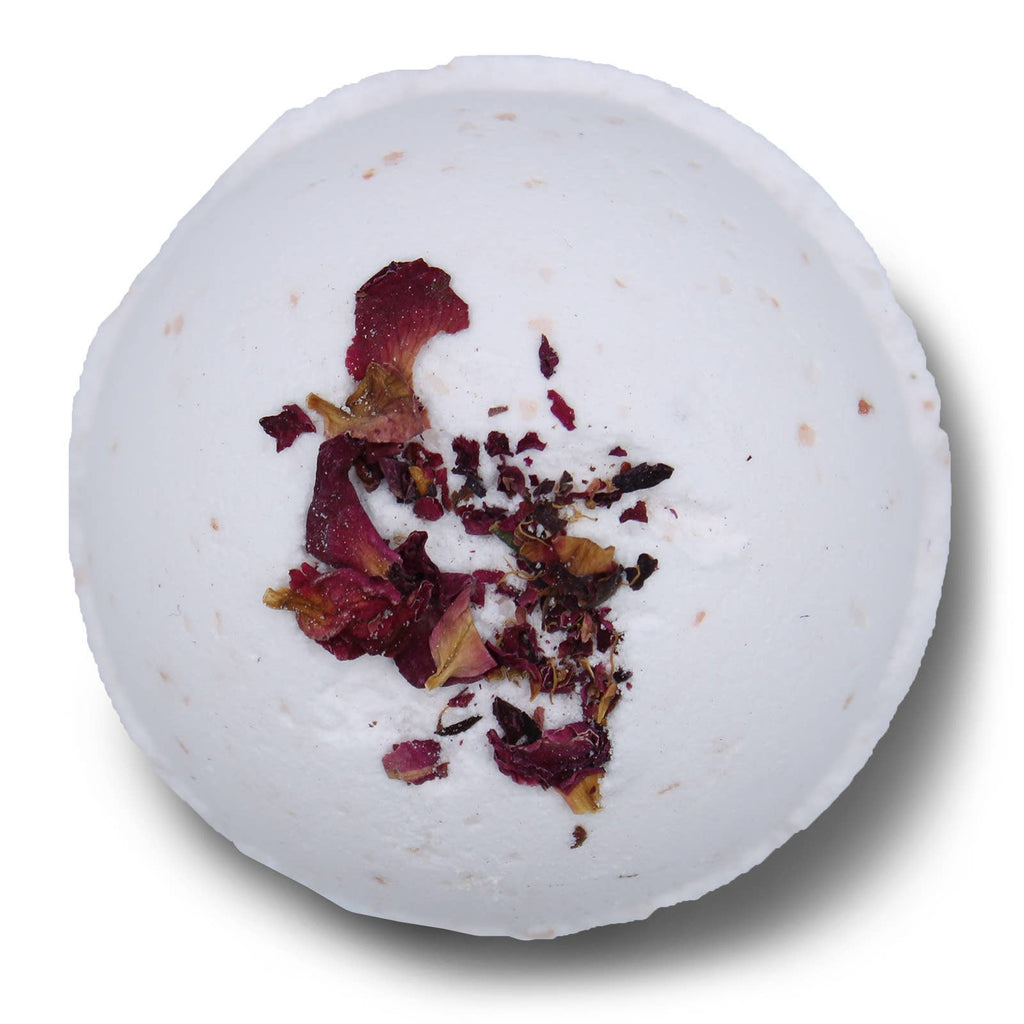 White bath bomb with dried flowers on a white background