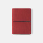 Red notebook with a silver strap on a white background