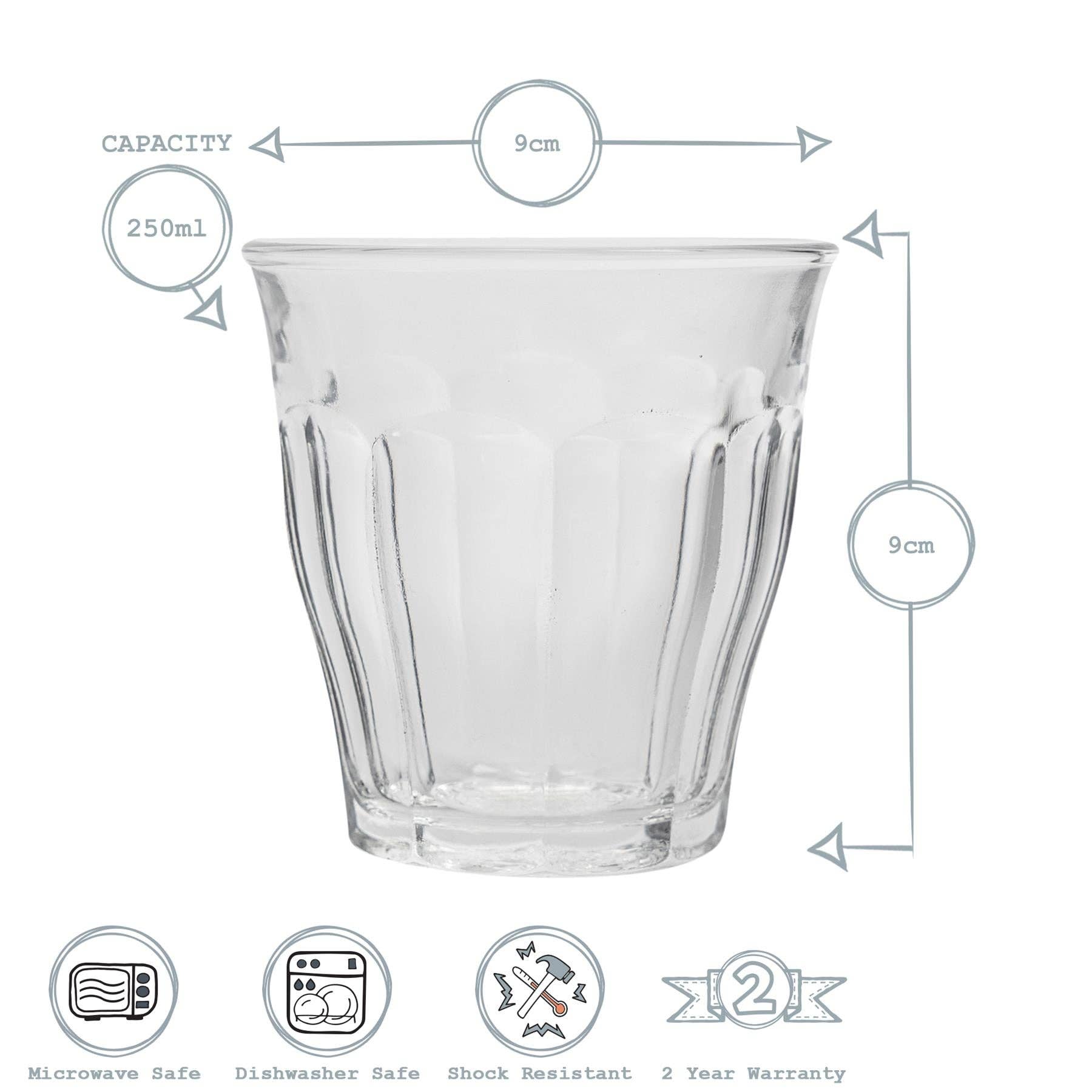 Clear glass tumbler with measurements and safety features on a white background