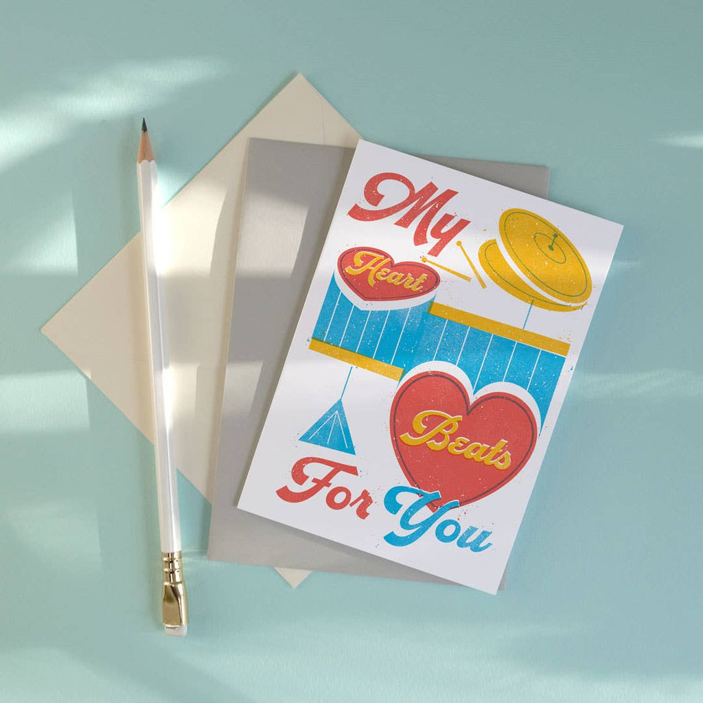 Greeting card with heart design and envelope on a light blue background