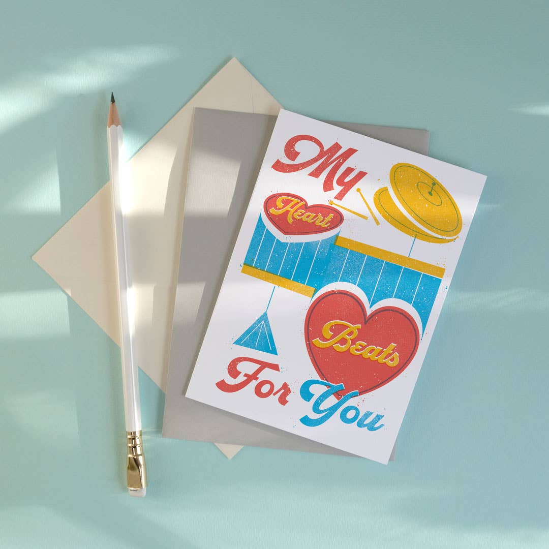 Greeting card with heart design and envelope on a light blue background