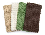 Four crocheted dishcloths in beige, white, green, and brown on a white background