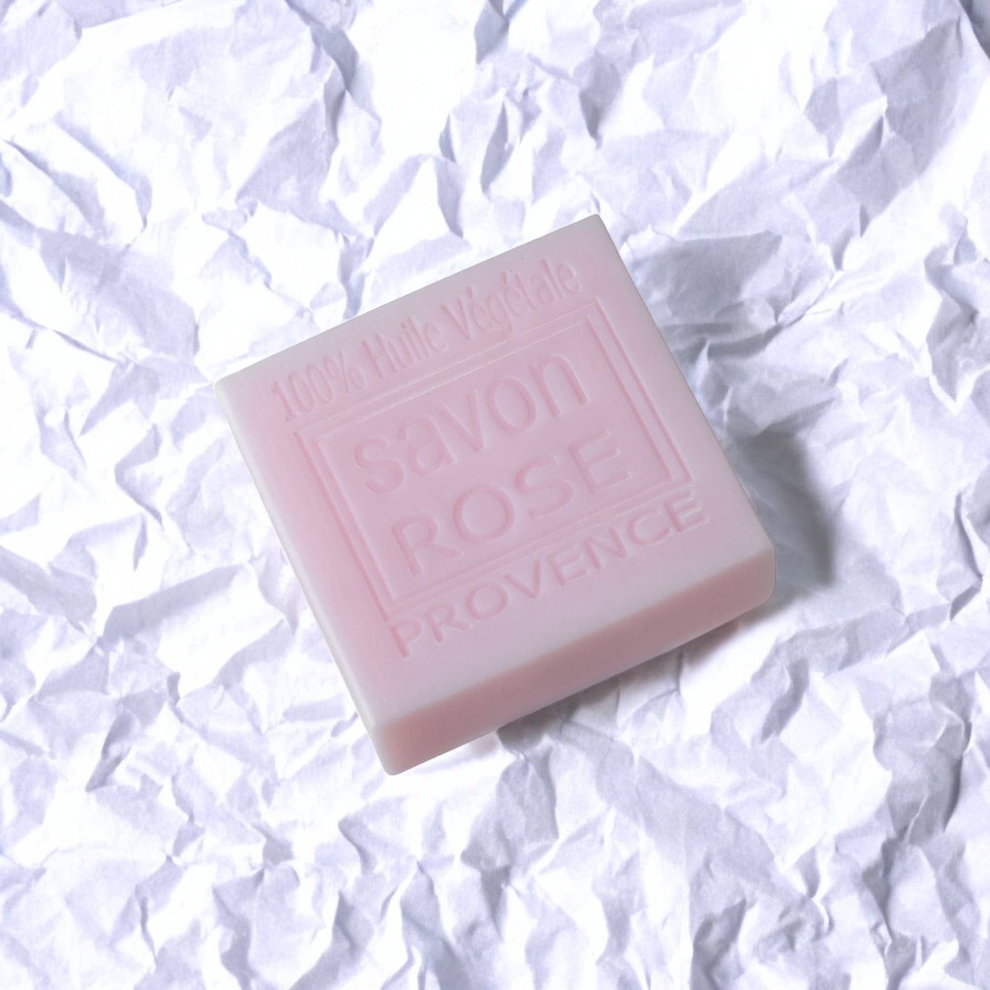 Pink soap bar with 'Savon Rose Provence' text on a white crumpled paper background