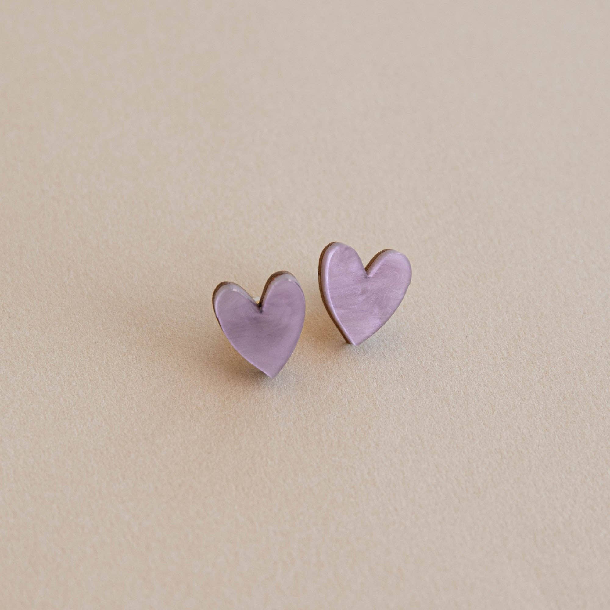 Heart-shaped earrings on a beige background