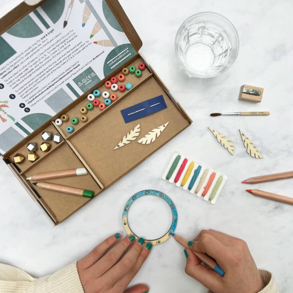 Artistic craft kit with tools and materials on a white surface