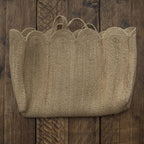 Woven basket with scalloped edge on a wooden surface