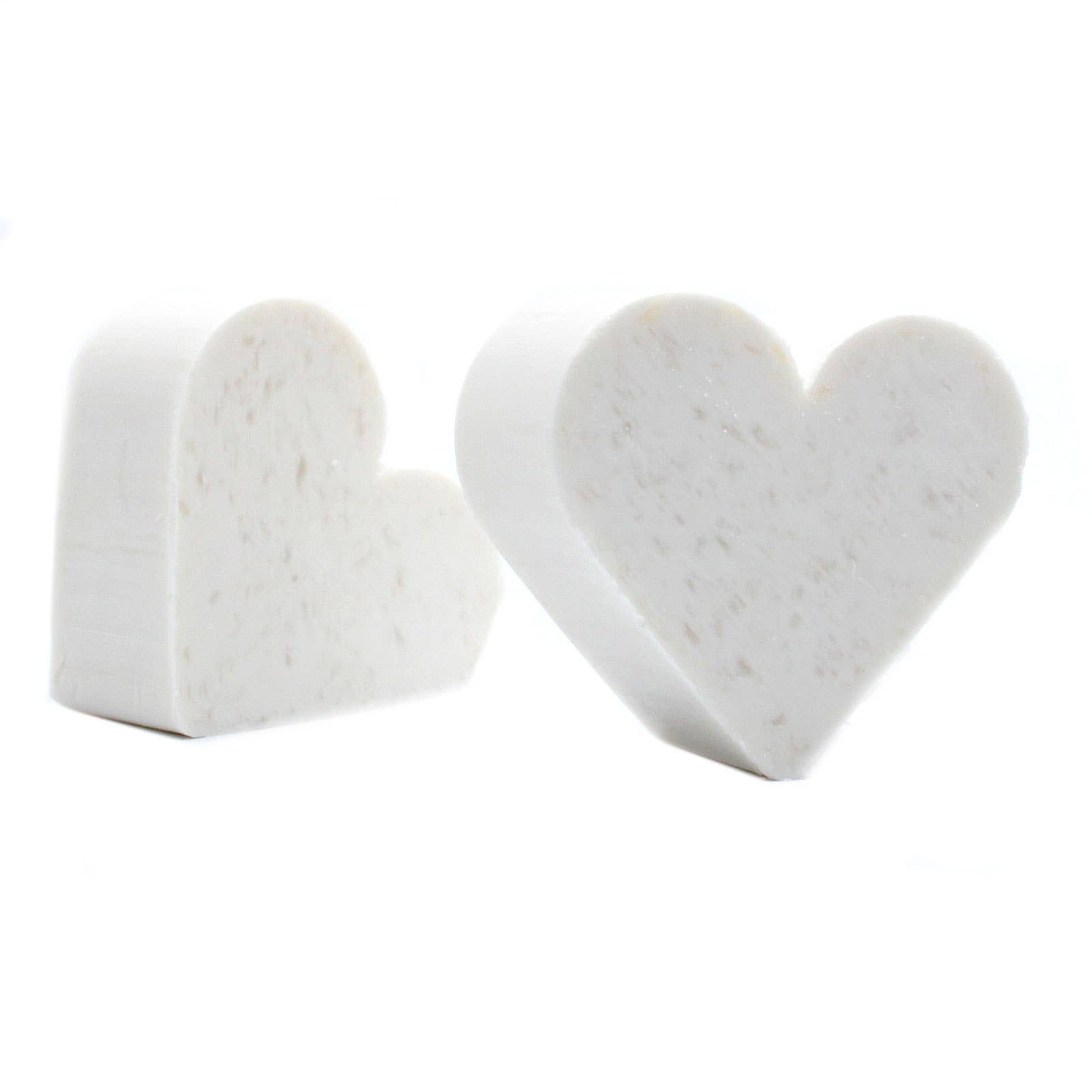 Heart-shaped white marble objects on a white background
