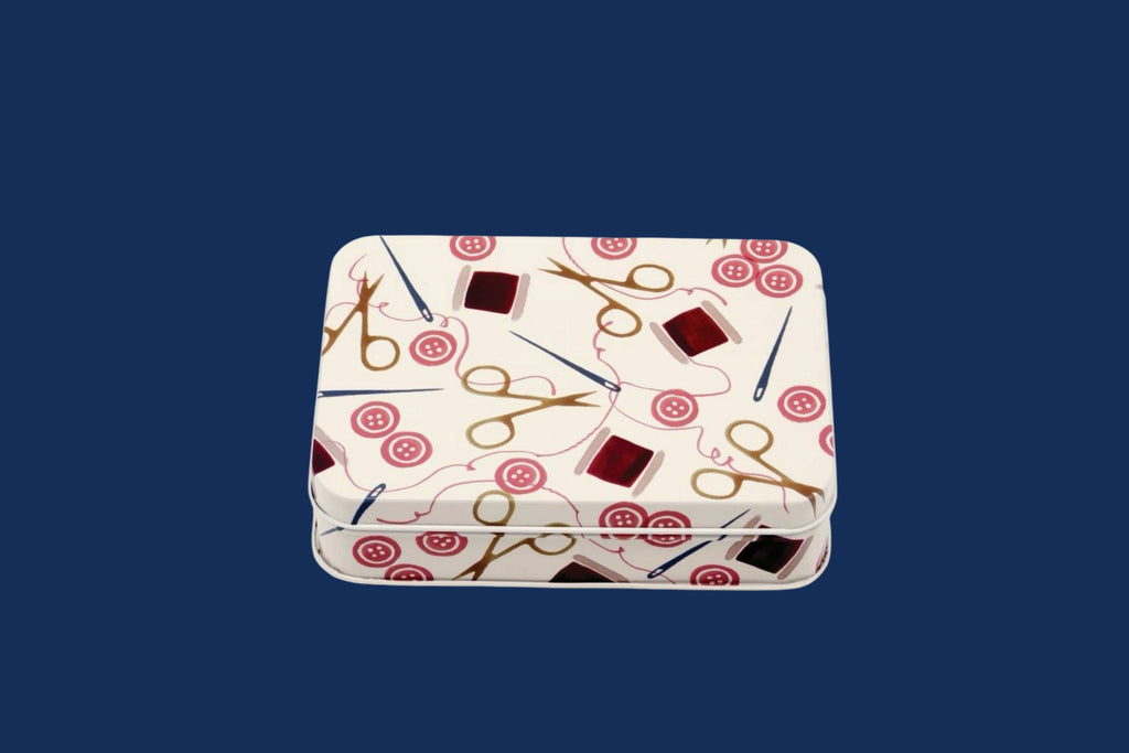 Rectangular tin with scissors and circle pattern on a blue background