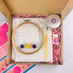 Embroidery kit with hoop, thread, and tools in a box