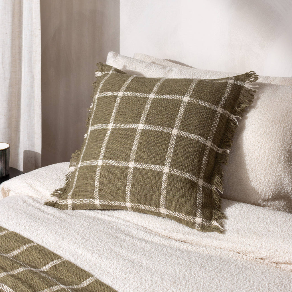 moss green check cushion on fluffy bed