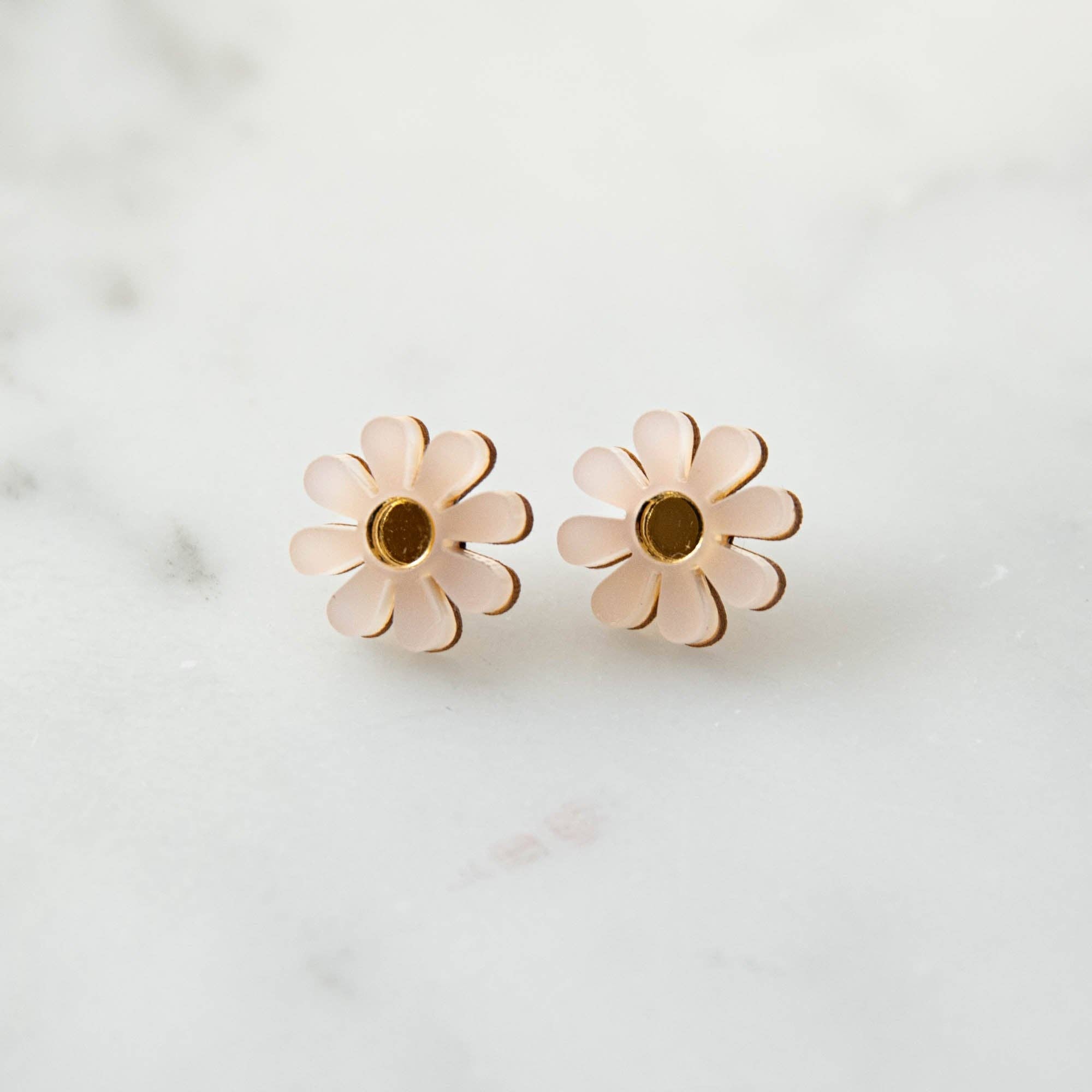 Pair of flower-shaped earrings on a light background