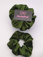Two green scrunchies with a 'NerdyPud' branded card on a white background