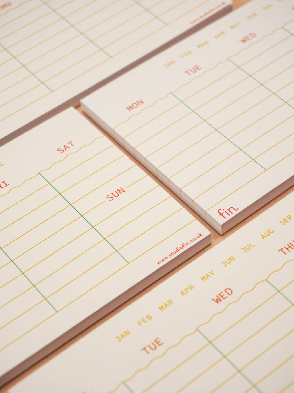 Small calendar pads with days of the week printed on them.