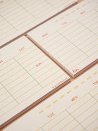 Small calendar pads with days of the week printed on them.