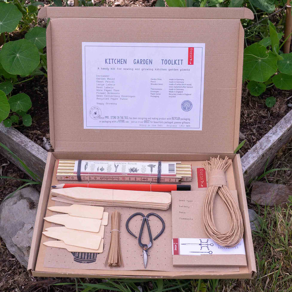 Kitchen garden tool kit with tools and packaging on a natural background
