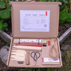 Kitchen garden tool kit with tools and packaging on a natural background