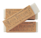 Two bars of stain remover soap with decorative brown packaging on a white background