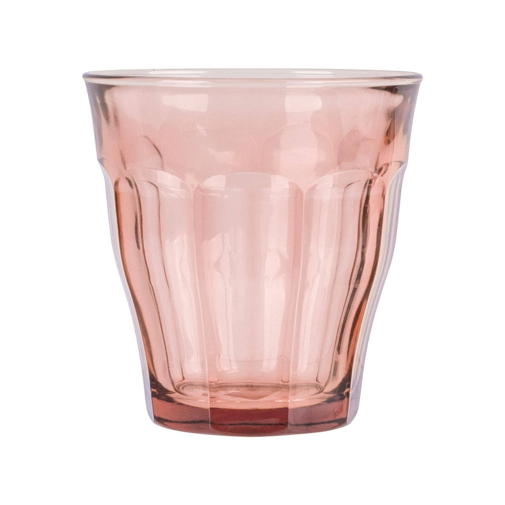 Pink glass tumbler on a white background