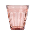 Pink glass tumbler on a white background