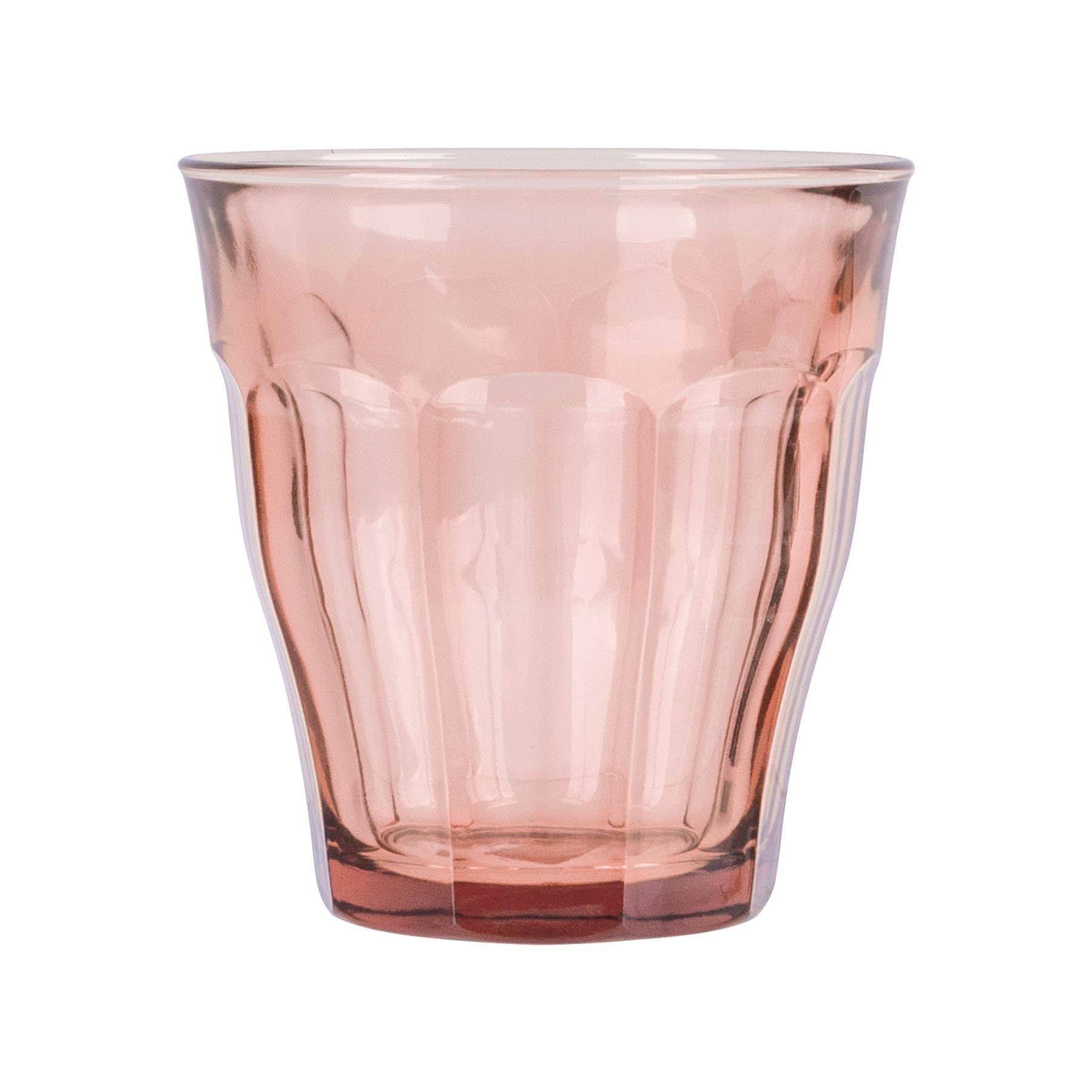 Pink glass tumbler on a white background