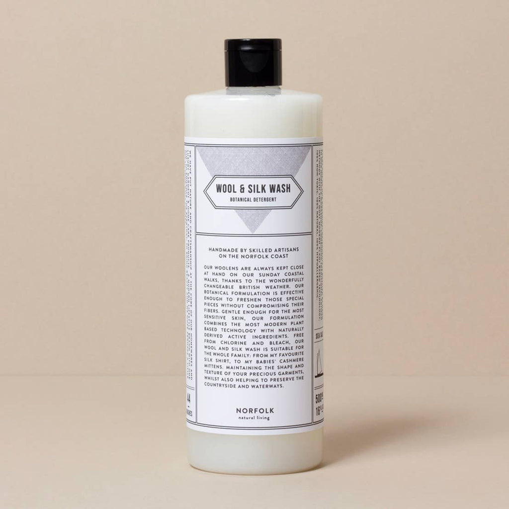 Bottle of Wool & Silk Wash on a beige background