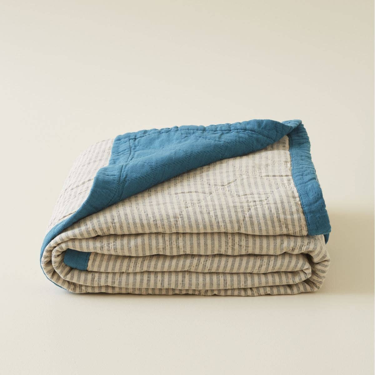 blue and beige striped quilt bedspread
