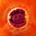Red bath bomb with a pumpkin design on an orange background