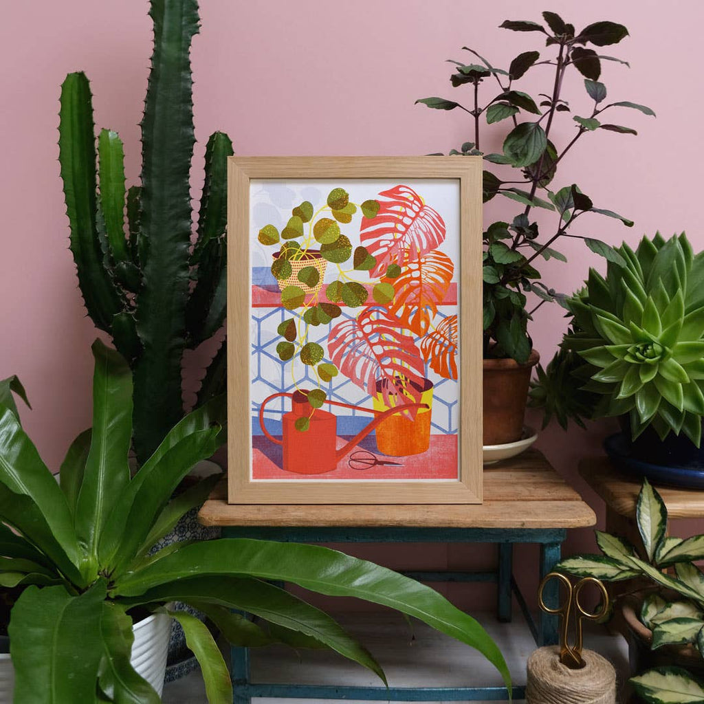 Framed artwork with plants on a pink wall