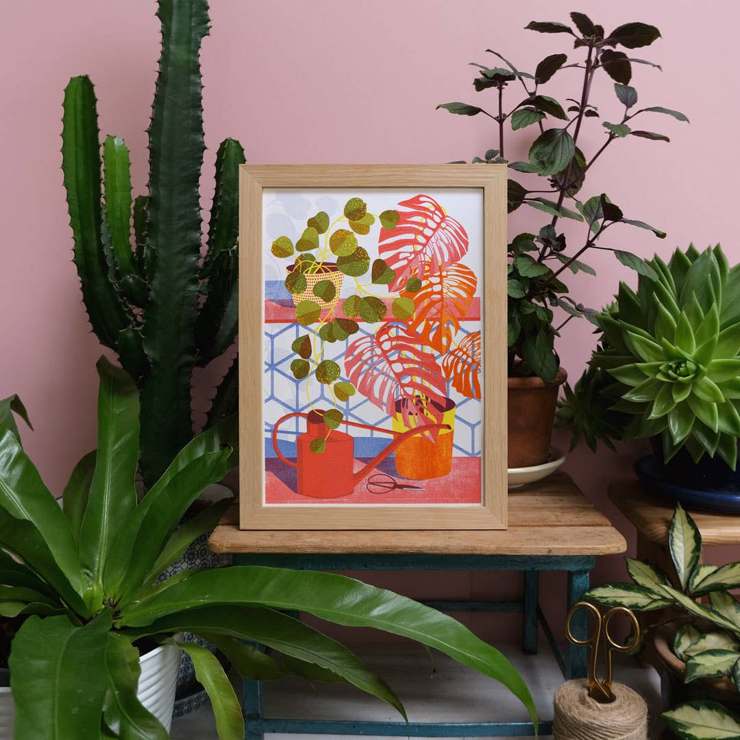 Framed artwork with plants on a pink wall