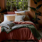 Bed with colorful pillows and quilts 