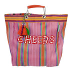 Colorful striped bag with 'CHEERS' text and tassel on a white background