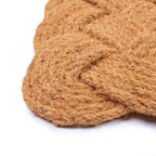 Close-up of a textured brown doormat on a white background